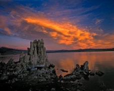 A cloud bank is illuminated by the sun, which has completed set.  Birds have retreated to their nests.  Nightfall in the tufa formation at Mono Lake.  Lee Vining, CA.
