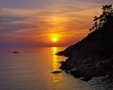 The last light of a glorious sunset plays on the granite shoreline of Lake Superior as the fishermen return after a busy day.  I wonder what they caught?  Twilight Resort, Lake Superior Provincial Park, Ontario, Canada